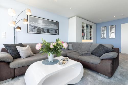 a living room with a couch and a table at Aloha Suite in Fehmarn
