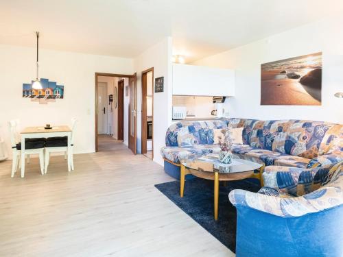 a living room with a couch and a table at Waldstraße 2 Ferienwohnung Volkenborn in Kellenhusen