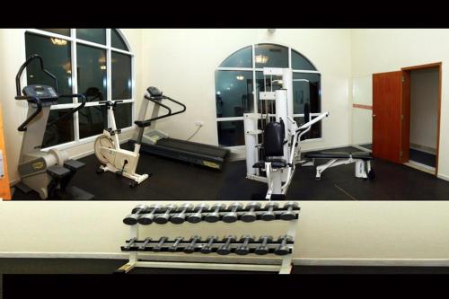 a room with a gym with a treadmill and weights at Basma Residence Hotel Apartments in Sharjah