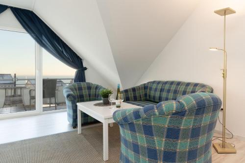 a living room with two chairs and a table at Seepferdchen Wulkje in Hansaland