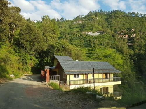a house on the side of a mountain at Dhruvs Nest Ramgarh Nainital in Rāmgarh