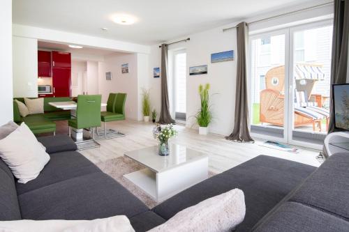 a living room with a couch and a table at Wohnung 2 in Haffkrug