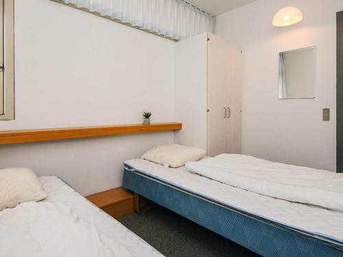 En eller flere senge i et værelse på 4 person holiday home in Ringkøbing-By Traum