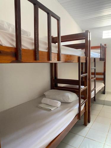 a room with three bunk beds in a hostel at Residence Brisa in Jericoacoara
