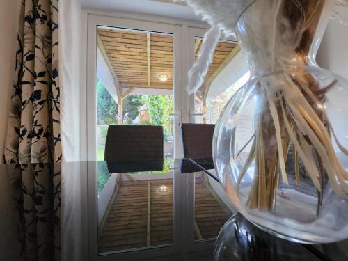 a vase with a plant in it next to a window at Newly Refurbished 3 Bedroom House with Lovely Garden in Bolton