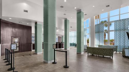 a lobby with green columns and a bench in a building at Laketown Wharf 834 in Panama City Beach