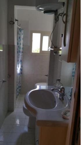 a bathroom with a sink and a toilet at Casetta Glicine in Ischia Town
