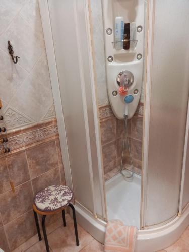 a shower in a bathroom with a stool next to it at Masía La Molinera in La Pelechaneta