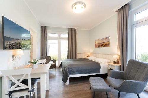 Ένα ή περισσότερα κρεβάτια σε δωμάτιο στο Strandresidenz Vogelflug Sundperle