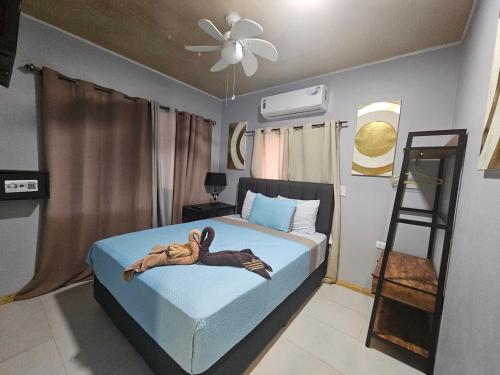 a bedroom with a bed with a person laying on it at Ballena Rey Hotel in Uvita