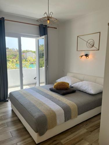 a bedroom with a bed and a large window at Apartments by the sea Potocnica, Pag - 222 in Novalja