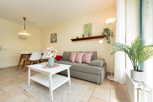 a living room with a couch and a table at Lange Wiese 16b in Dahme