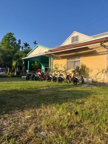 a group of motorcycles parked in front of a house at 十畝田山莊會館 in Chishang