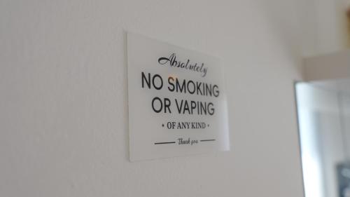 a no smoking sign hanging on a wall at Il Vicoletto B&B in Cirò Marina
