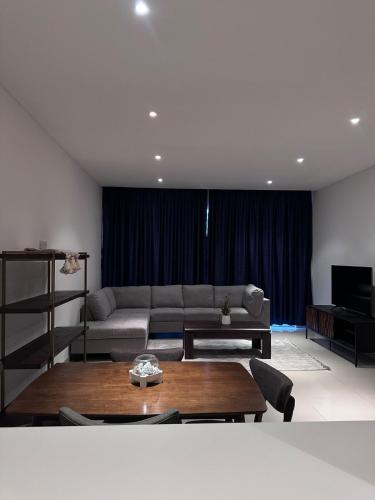 a living room with a couch and a table at Brand new apartmentWith a nice view balcony in Seeb