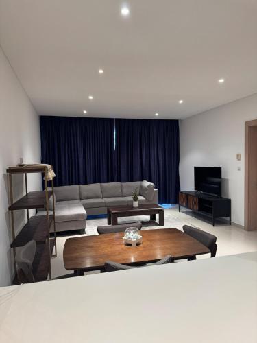 a living room with a couch and a table at Brand new apartmentWith a nice view balcony in Seeb