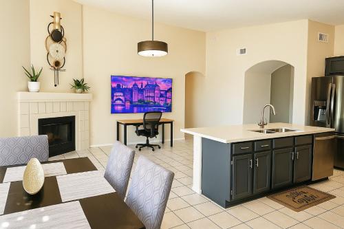 a kitchen and living room with a sink and a table at North Phoenix At Your Fingertips in Phoenix