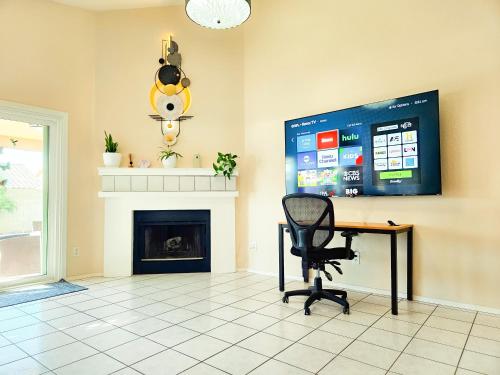 a room with a desk and a chair and a screen at North Phoenix At Your Fingertips in Phoenix