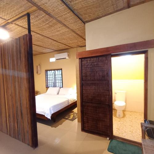 a bedroom with a bed and a toilet at Madam Sokha Homesteading in Siem Reap
