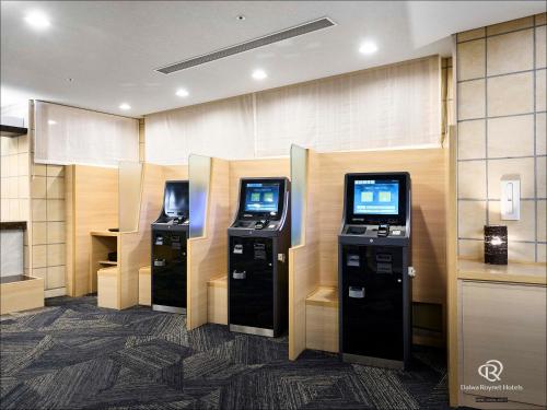 a lobby with three video game machines in a room at Daiwa Roynet Hotel Morioka in Morioka