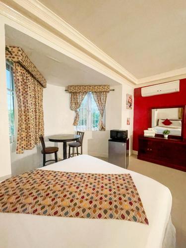 a bedroom with a bed and a table in a room at Golden Palms House in Nassau