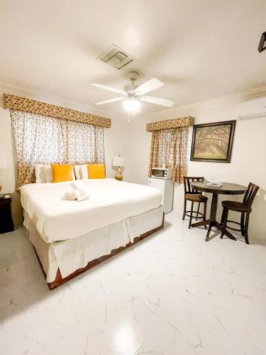 a bedroom with a large bed and a table at Golden Palms House in Nassau