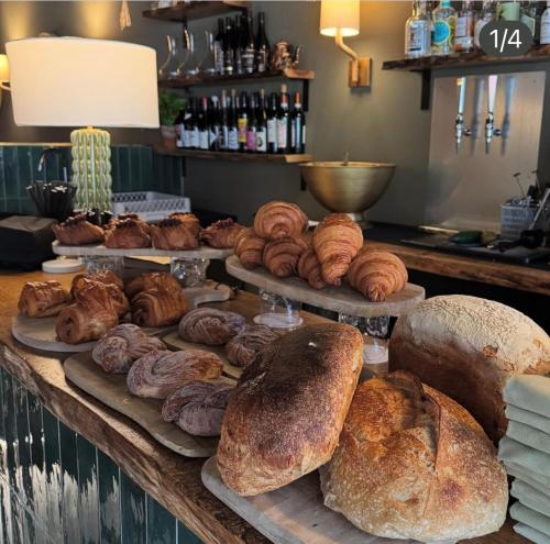 a table with different types of bread and pastries at The Goose lodge in Calveley