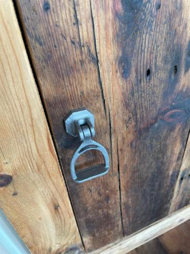 a wooden door with a metal lock on it at The Goose lodge in Calveley