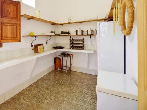 a kitchen with white counters and a white refrigerator at Holiday Home in Migjorn with Private Pool in Llucmajor