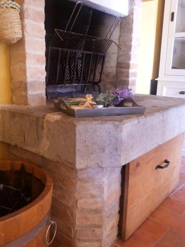 a stone fireplace in a living room with a mantle at Casa Cesira in Tarzo