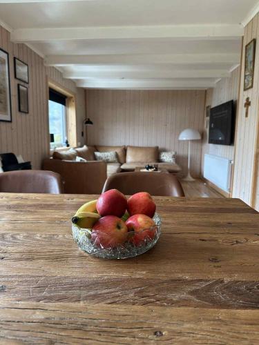 a bowl of fruit on a table in a living room at Beggustova - located in Kaldbak village, close to Tórshavn in Kaldbak