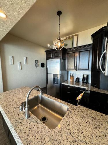 a kitchen with a sink and a refrigerator at Palacio Del Mar - Oceanfront in Puerto Peñasco