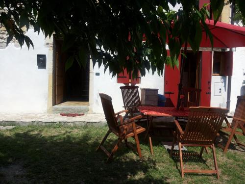 a table and chairs sitting under a tree at Casa Cesira in Tarzo