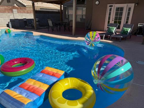 a swimming pool with colorful inflatables in it at Newly Remodeled Pool Villa 3BD 3BA By Summerlin in Las Vegas