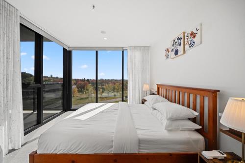a bedroom with two beds and a large window at Stylish 2-Bed Apartment with Luxe Amenities Access in Phillip