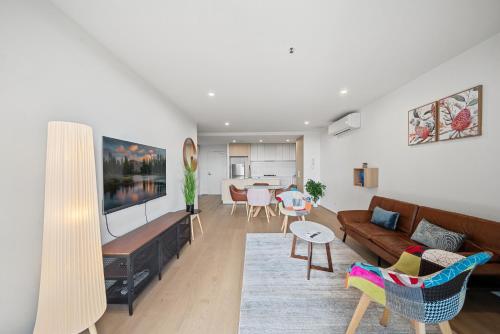 a living room with a couch and a table at Stylish 2-Bed Apartment with Luxe Amenities Access in Phillip