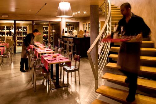 a dining room with tables and people in a restaurant at Hotel Lamberti in Alassio