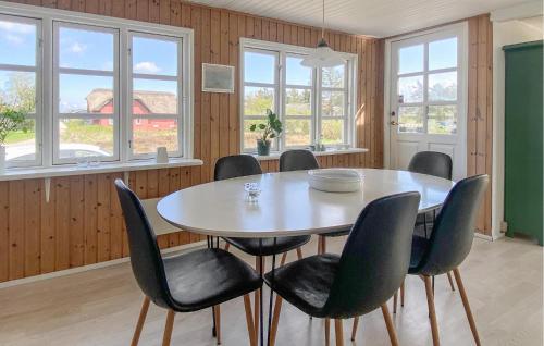 a dining room with a table and chairs at Holiday Home Børkop With Sea View Vi in Børkop