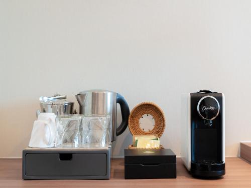 two appliances are sitting on a wooden table at Olive Tree Hotel Penang in Bayan Lepas