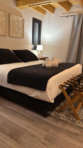 a bedroom with a large bed and a chair at NB Mountain aparts El Chalten in El Chalten