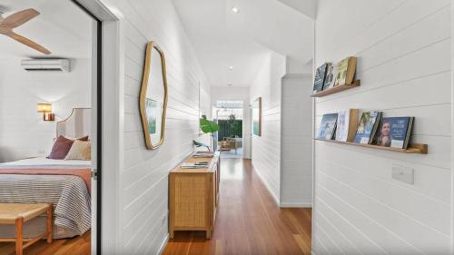 a bedroom with a bed and a mirror at Fletcher Lane Boutique Stay Byron Central in Byron Bay