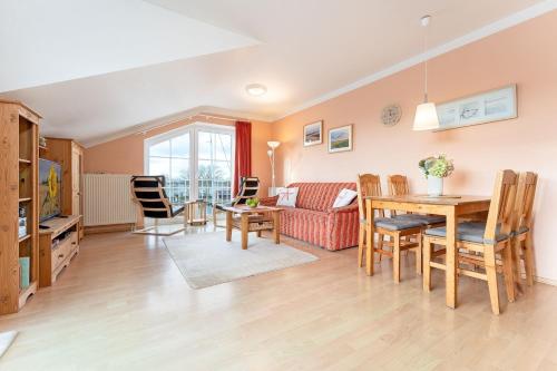 a living room with a table and a couch at Am Hafen 2d Inselsonne 2 in Orth