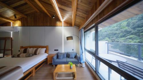 a bedroom with a bed and a large window at Nanjing Tulou Xinyuan HomeStay in Nanjing