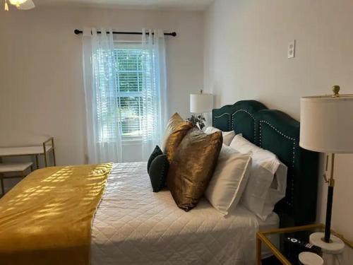 a bedroom with a bed with pillows on it at Chic Centrally Located 2BR Townhome at the Rez Sleeps 6 in Brandon