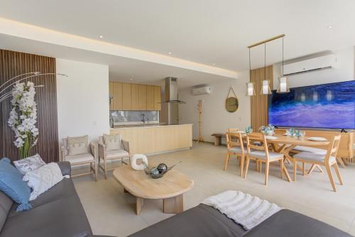 a living room and kitchen with a couch and a table at Aria Ocean Condominios in Nuevo Vallarta 