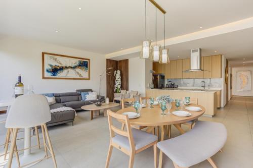 a kitchen and living room with a table and chairs at Aria Ocean Condominios in Nuevo Vallarta 