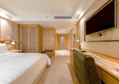 Postel nebo postele na pokoji v ubytování Royal Dragon Hotel