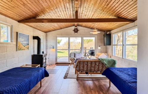 a living room with two beds and a table at Awesome Home In Samsø With Wifi in Nordby