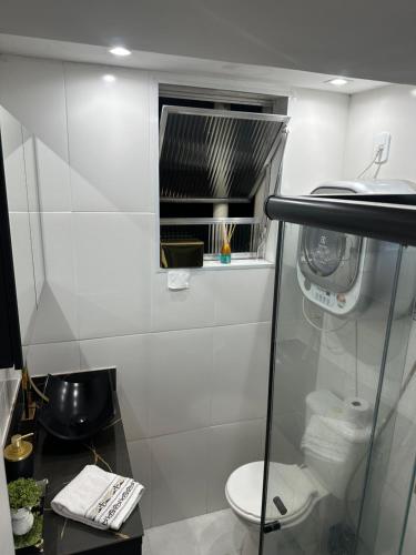 a bathroom with a toilet and a window at Locação temporada na Serra in Petrópolis