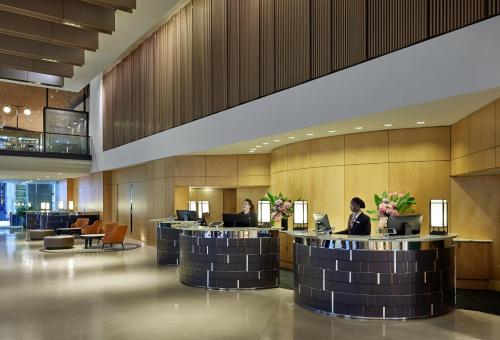 シドニーにあるThe Fullerton Hotel Sydneyのロビーでコンピューターの前に座っている人々がいるロビー
